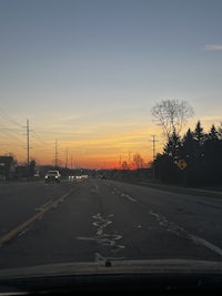 a road with cars on it at sunset